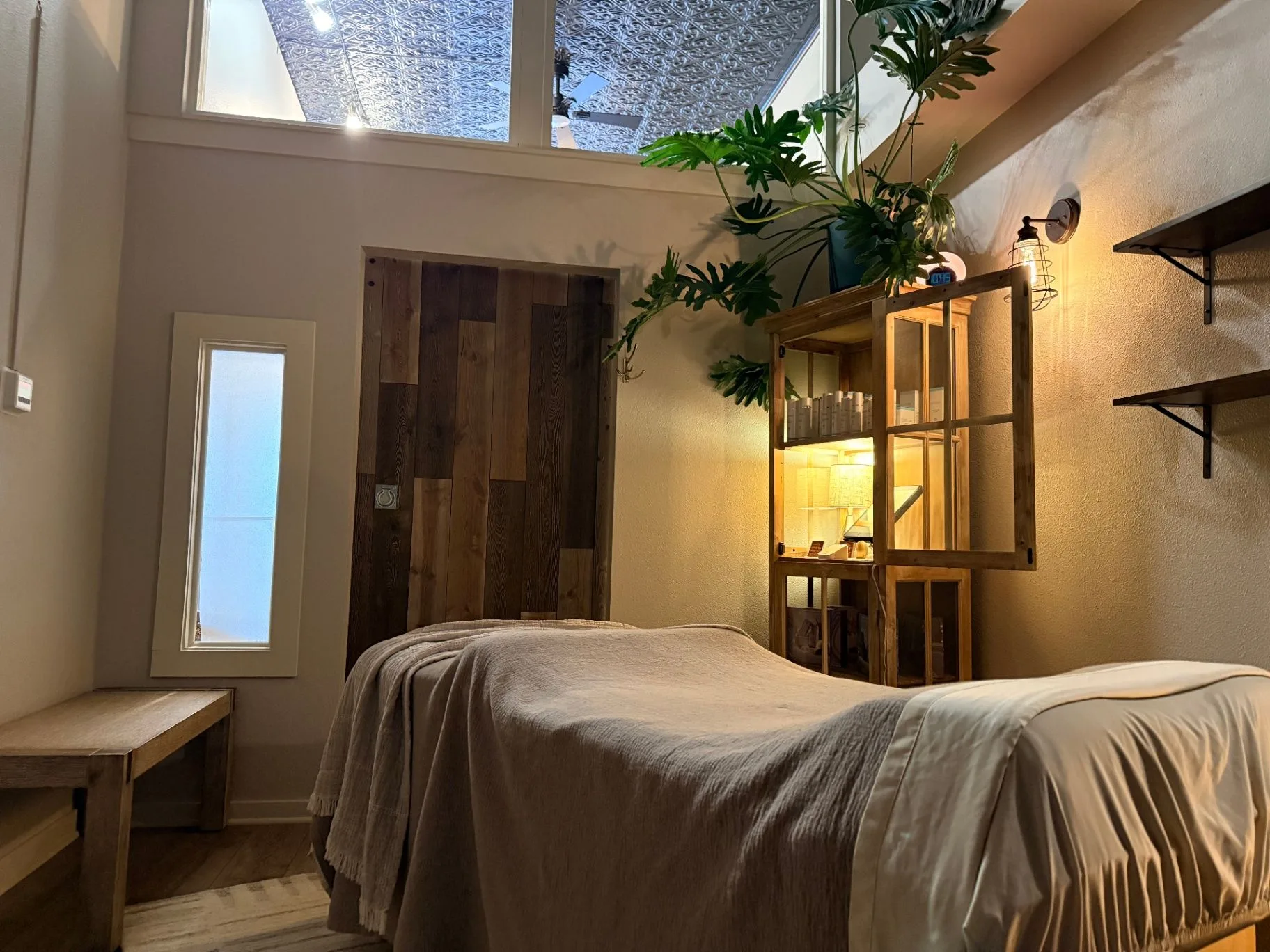 Pure Skin treatment room in Windsor, Colorado, with a light treatment bed and greenery.