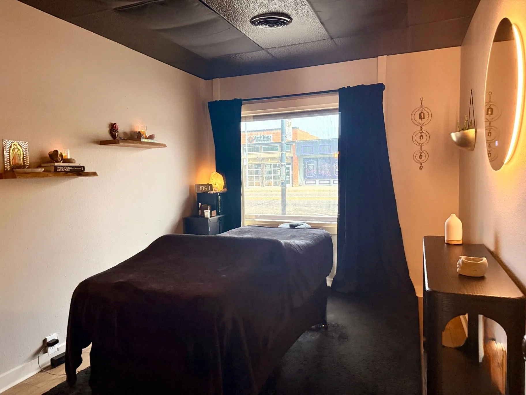 Black treatment bed in the Source Six Wellness room at Root + Ritual.